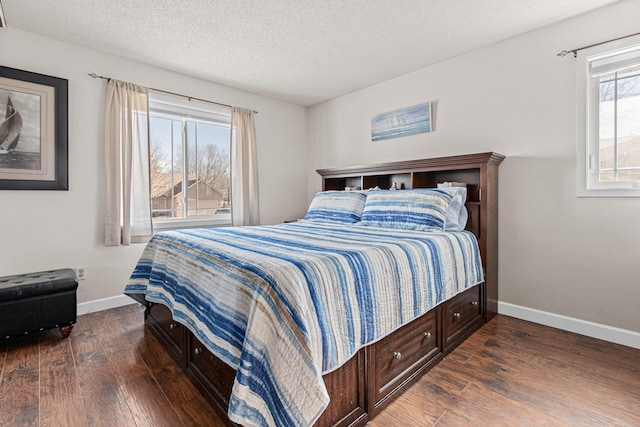 bedroom featuring wood finished floors, baseboards, and a textured ceiling