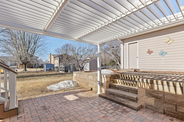 view of patio / terrace with an outdoor structure and a storage unit