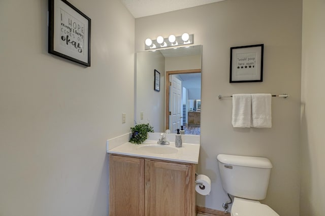 half bathroom featuring toilet and vanity