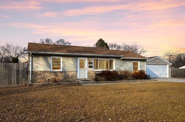 ranch-style house with concrete driveway, fence, a garage, and a lawn