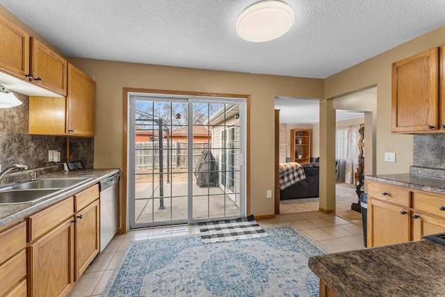 kitchen with a sink, backsplash, stainless steel dishwasher, and light tile patterned floors