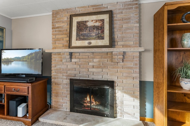 interior details featuring a brick fireplace and ornamental molding