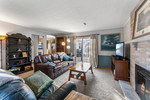 living area featuring crown molding, a brick fireplace, baseboards, and light carpet