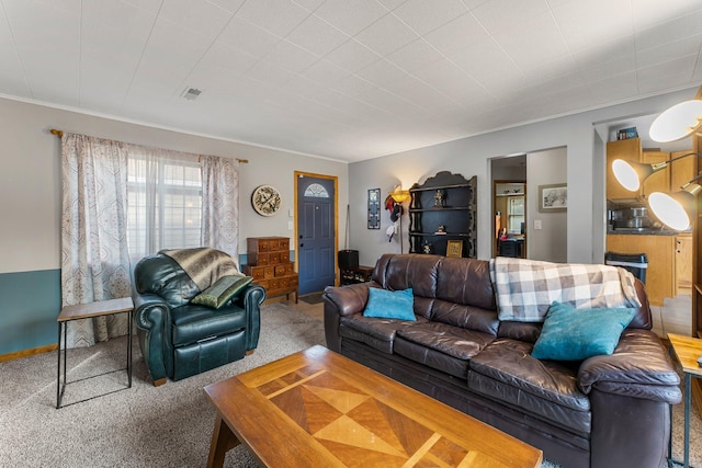 living room featuring crown molding, visible vents, and carpet floors