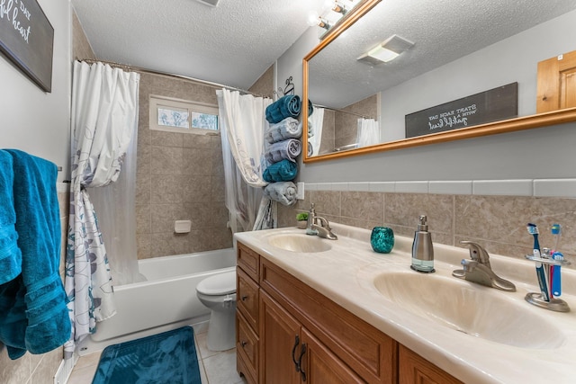 bathroom featuring a sink, a textured ceiling, and tile walls