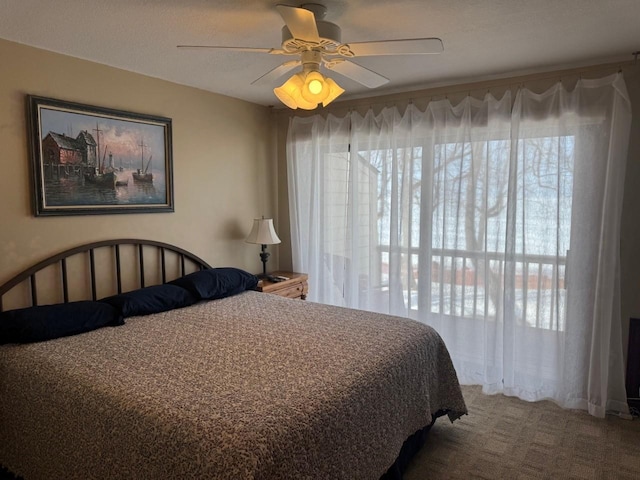 bedroom with carpet flooring, multiple windows, and ceiling fan