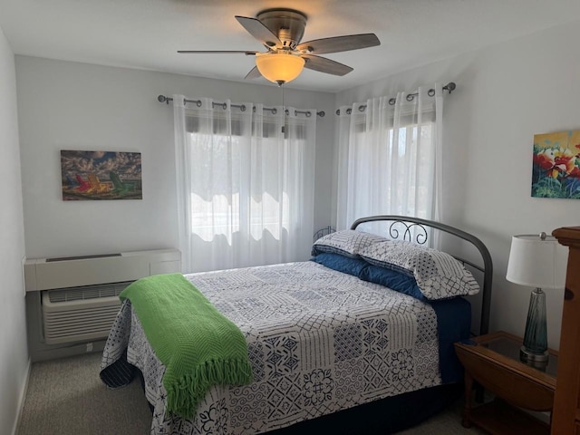 carpeted bedroom featuring a ceiling fan and a wall unit AC