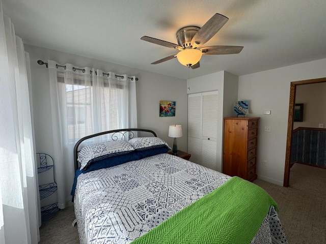 carpeted bedroom with a closet, baseboards, and ceiling fan