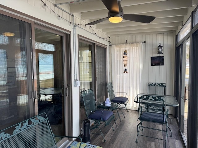 sunroom with beam ceiling and ceiling fan