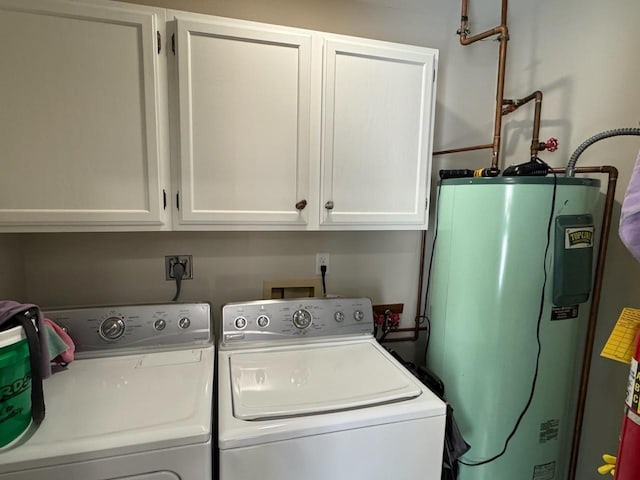 laundry area featuring cabinet space, electric water heater, and independent washer and dryer