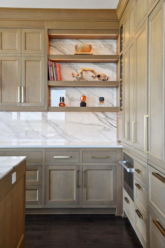 kitchen featuring open shelves, light stone counters, and tasteful backsplash