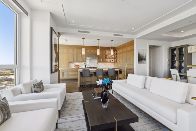 living area with recessed lighting, visible vents, and a wealth of natural light