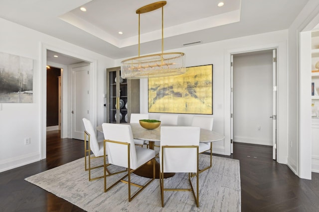 dining space featuring a raised ceiling, recessed lighting, baseboards, and visible vents