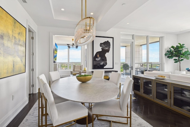 dining space with dark wood finished floors, recessed lighting, baseboards, and an inviting chandelier