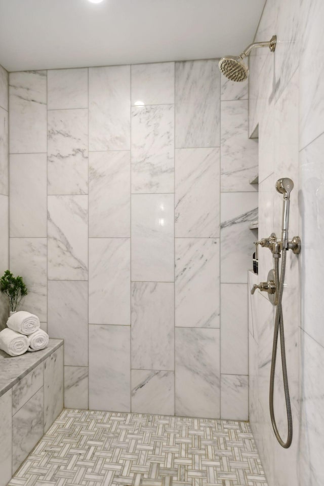 bathroom with a tile shower