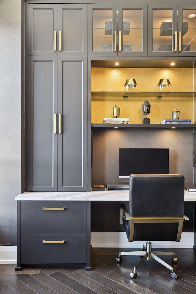 office space with dark wood-style floors and built in study area