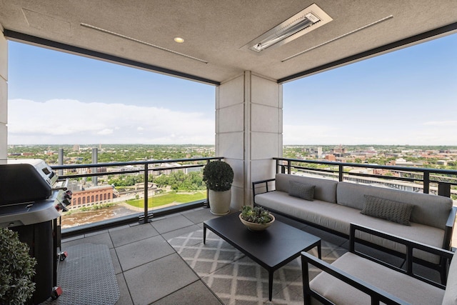 balcony featuring an outdoor living space, a city view, and a grill