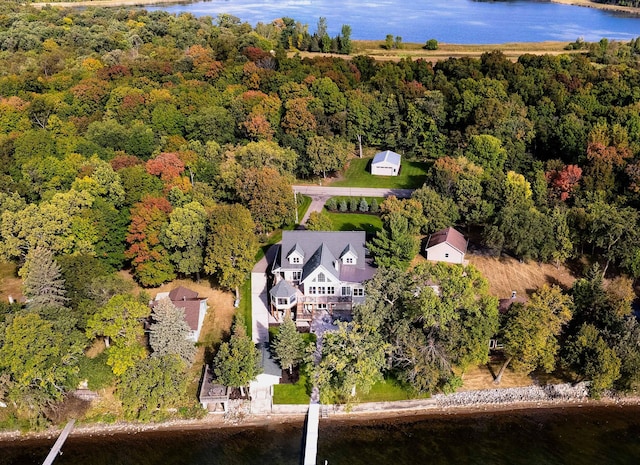 drone / aerial view featuring a forest view and a water view