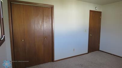 unfurnished bedroom with a closet and carpet flooring