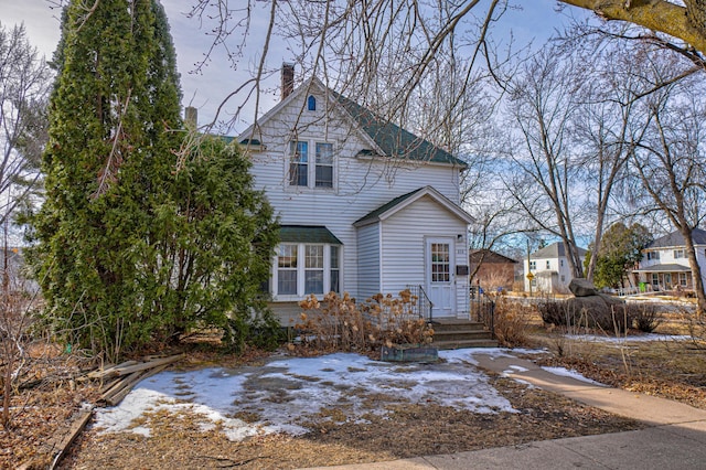 view of front of home featuring a chimney