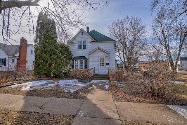 view of front of house featuring a chimney