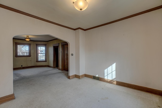 spare room with arched walkways, visible vents, and carpet floors