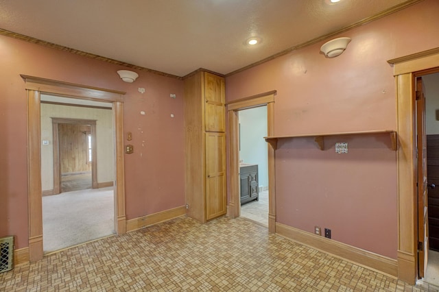 empty room featuring recessed lighting, baseboards, and crown molding