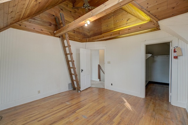 unfurnished bedroom with wooden ceiling, visible vents, light wood-style flooring, and vaulted ceiling with beams