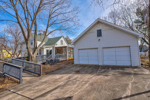 view of front of home with an outbuilding, covered porch, and a garage