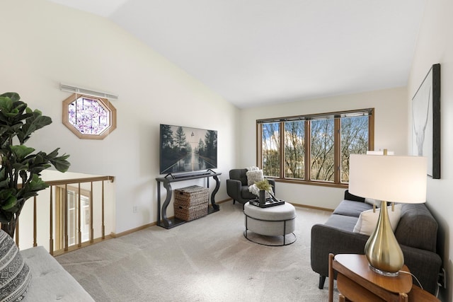 living area with baseboards, carpet floors, and high vaulted ceiling