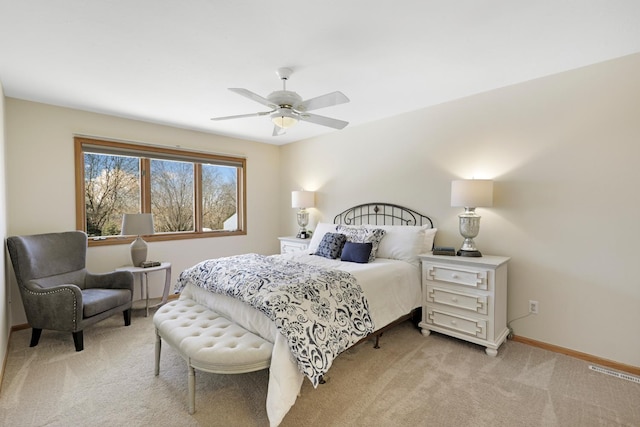 bedroom with visible vents, light colored carpet, a ceiling fan, and baseboards