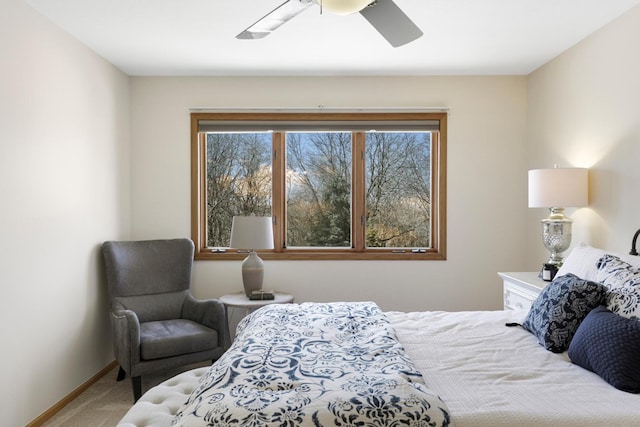 bedroom with ceiling fan, baseboards, and carpet floors