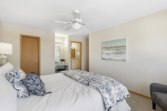 bedroom featuring carpet, baseboards, ensuite bathroom, and ceiling fan