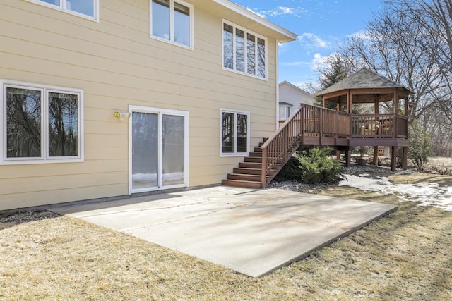 back of property featuring stairs, a gazebo, a patio area, and a wooden deck