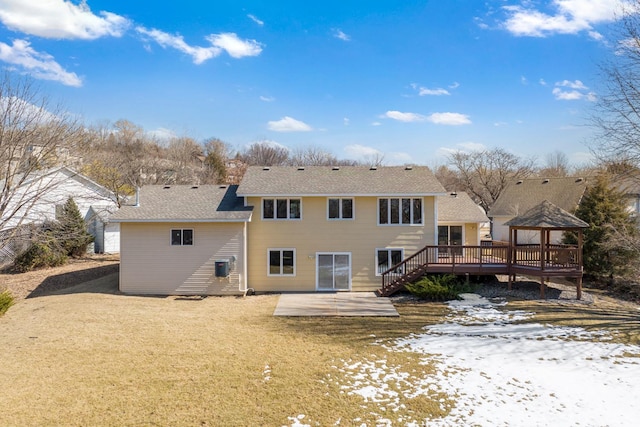 back of property featuring a gazebo, a yard, and a deck