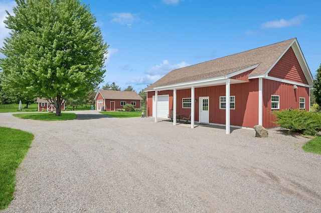 5191 Christen Ave NE, Buffalo, MN 55313 - exterior space featuring gravel driveway, an outbuilding, and board and batten siding