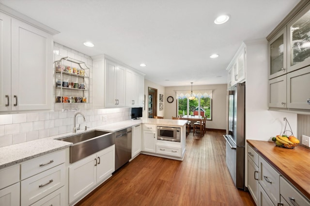 5191 Christen Ave NE, Buffalo, MN 55313 - kitchen with tasteful backsplash, butcher block counters, appliances with stainless steel finishes, an inviting chandelier, and a sink