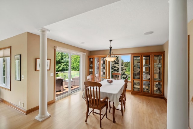 5191 Christen Ave NE, Buffalo, MN 55313 - dining space featuring light wood-style flooring, baseboards, and ornate columns