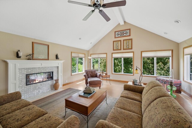 5191 Christen Ave NE, Buffalo, MN 55313 - living area with baseboards, beam ceiling, a tile fireplace, wood finished floors, and a ceiling fan