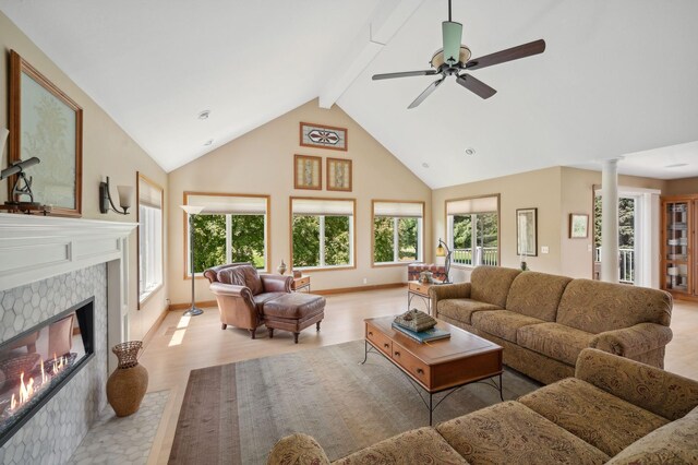 5191 Christen Ave NE, Buffalo, MN 55313 - living room with beam ceiling, a glass covered fireplace, light wood-style floors, and a wealth of natural light