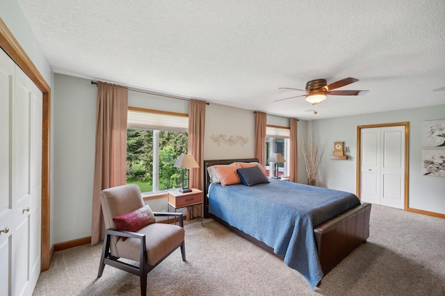 5191 Christen Ave NE, Buffalo, MN 55313 - bedroom featuring a ceiling fan, baseboards, a closet, a textured ceiling, and light colored carpet