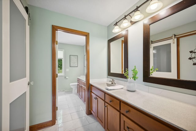 5191 Christen Ave NE, Buffalo, MN 55313 - bathroom with tile patterned flooring, toilet, vanity, and baseboards