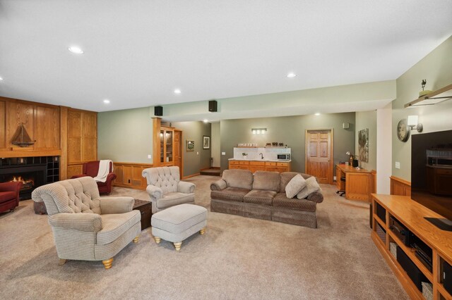 5191 Christen Ave NE, Buffalo, MN 55313 - living room with recessed lighting, light colored carpet, a wainscoted wall, and a tile fireplace