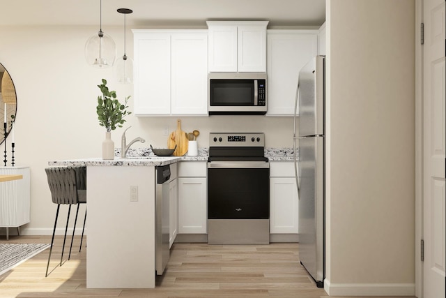 kitchen with white cabinetry, a peninsula, light wood-type flooring, and stainless steel appliances