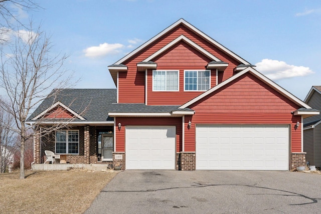 craftsman-style home featuring brick siding, driveway, and a shingled roof