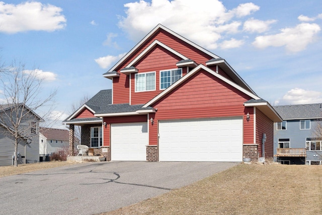 craftsman inspired home featuring stone siding and driveway