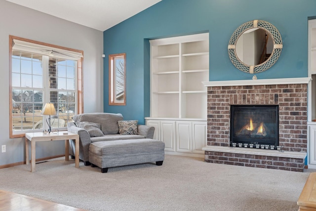 living room featuring baseboards, carpet, a fireplace, and vaulted ceiling