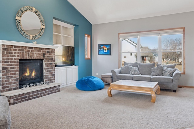 living area with built in features, baseboards, carpet floors, lofted ceiling, and a brick fireplace