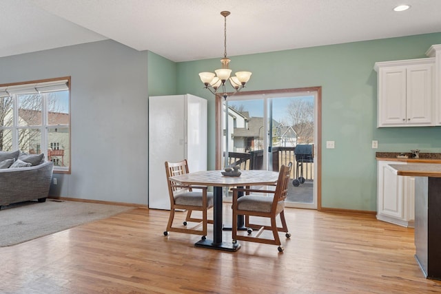 dining room featuring a chandelier, recessed lighting, light wood-style flooring, and baseboards