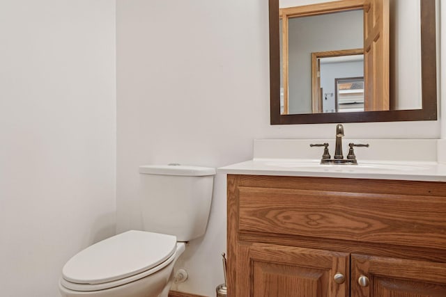 half bathroom featuring toilet and vanity